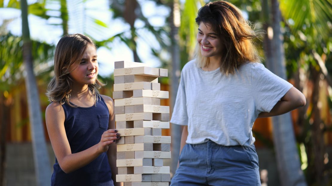 A girl and a woman playing Jenga GIANT