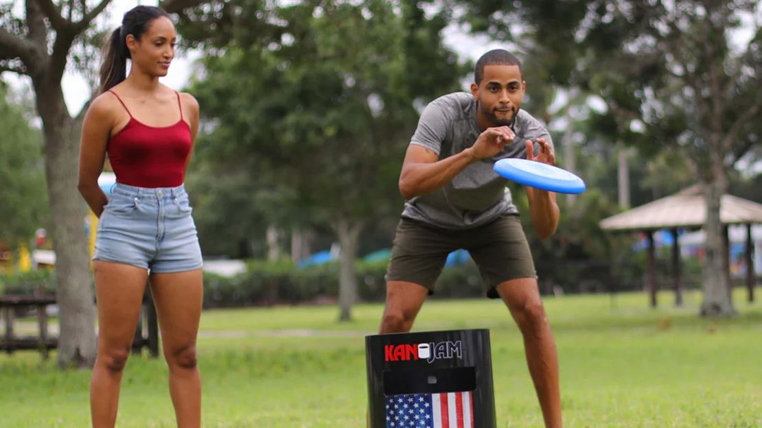 Two people shown playing the Kan Jam frisbee game