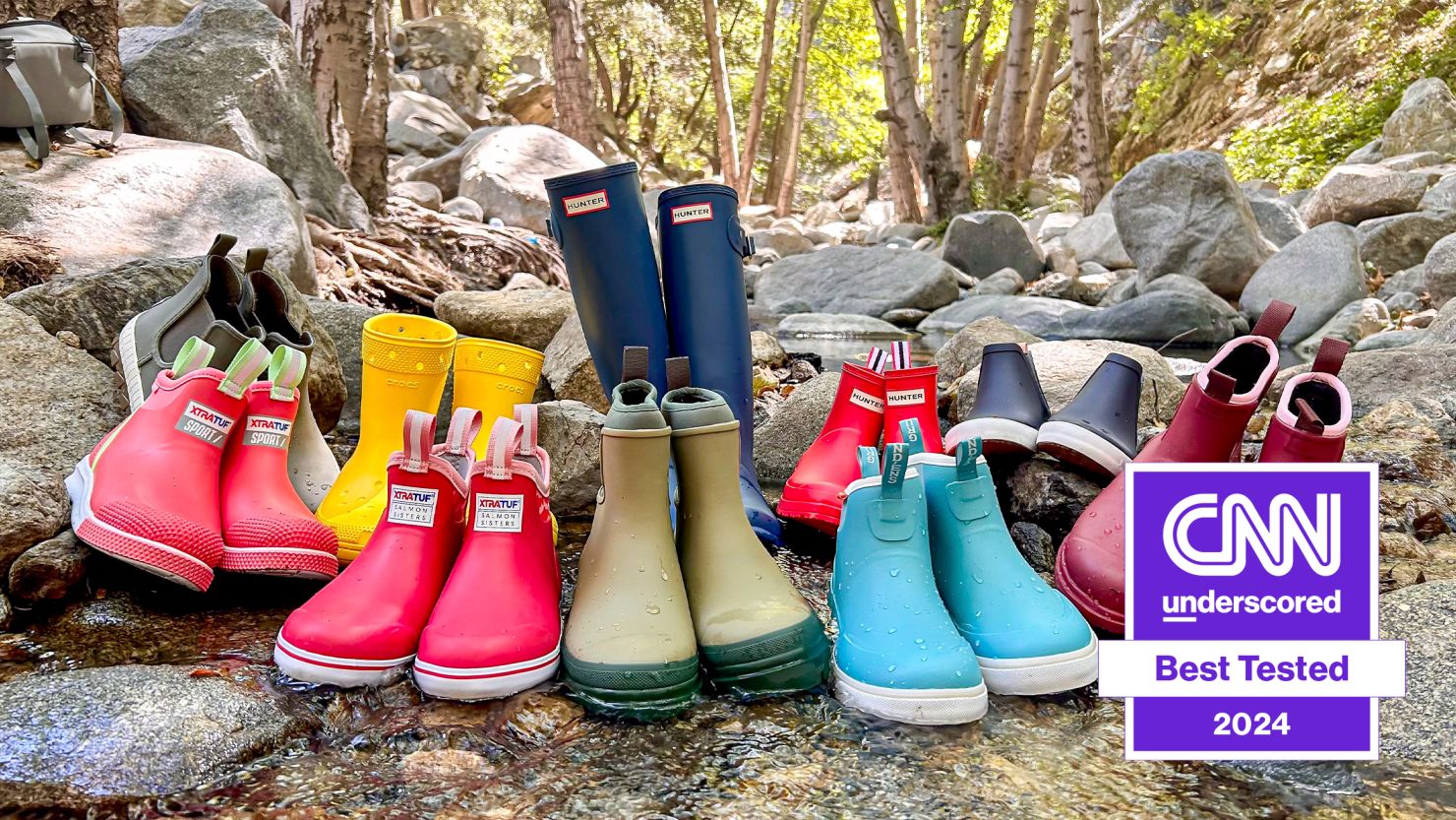 10 rain boots placed on the rocks of a river.