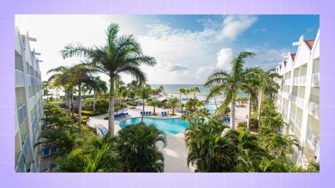 A photo of a resort with a pool and palm trees