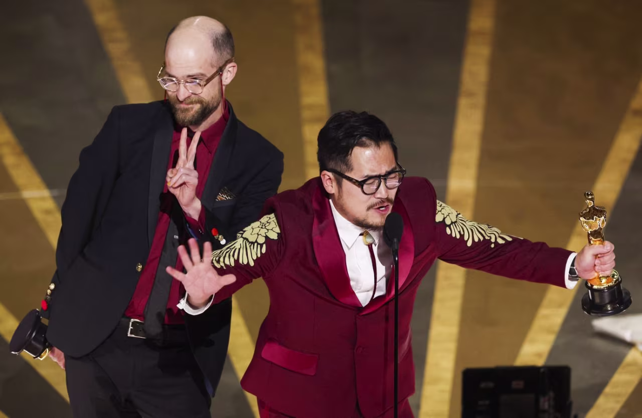 Daniel Scheinert, left, and Daniel Kwan accept the award for best original screenplay for "Everything Everywhere All At Once". 