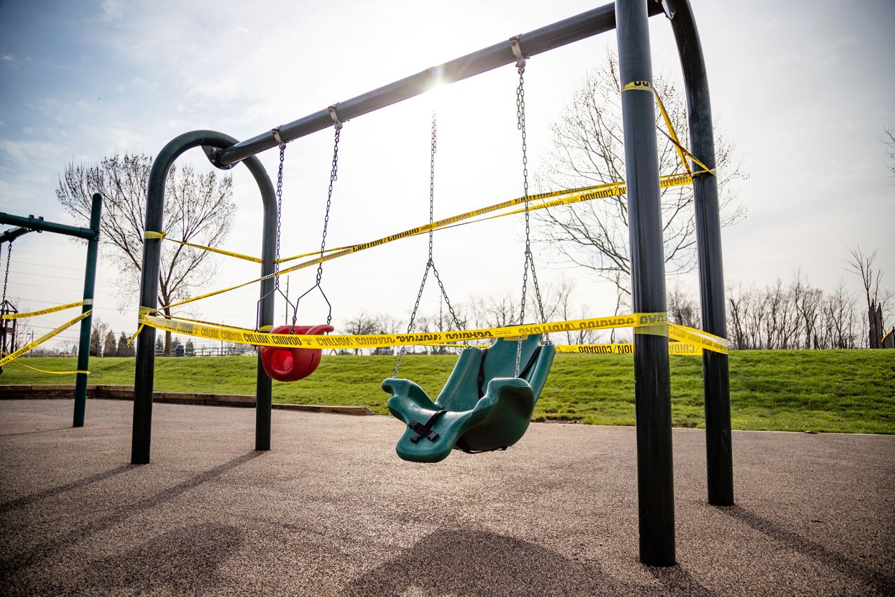 Playground equipment is cordoned off with yellow caution tape at the Veteran's Memorial Park on Harrison Avenue in Cincinnati, Ohio, in the wake of the coronavirus pandemic on Thursday, March 24.