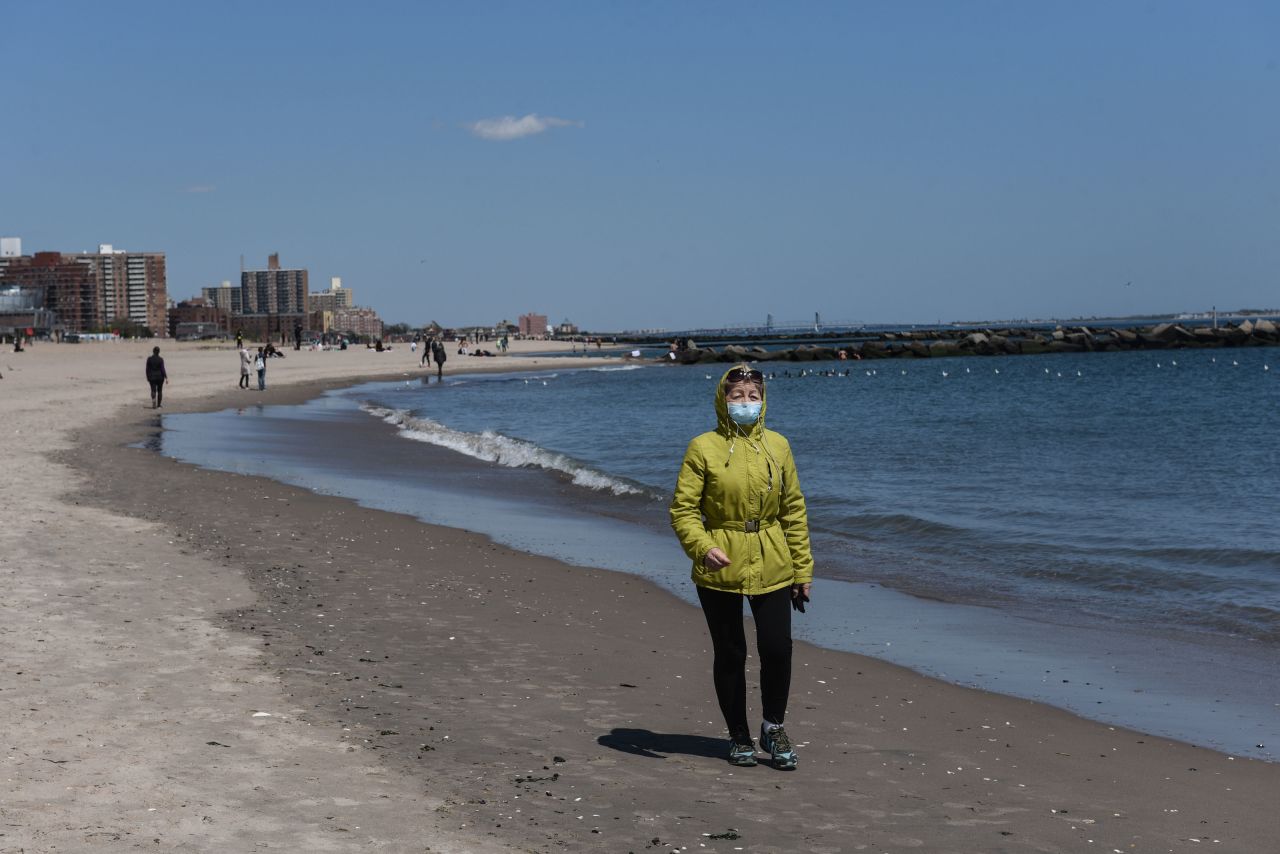 A person walks on the beach on May 13 in the Coney Island neighborhood in the Brooklyn borough in New York City. 