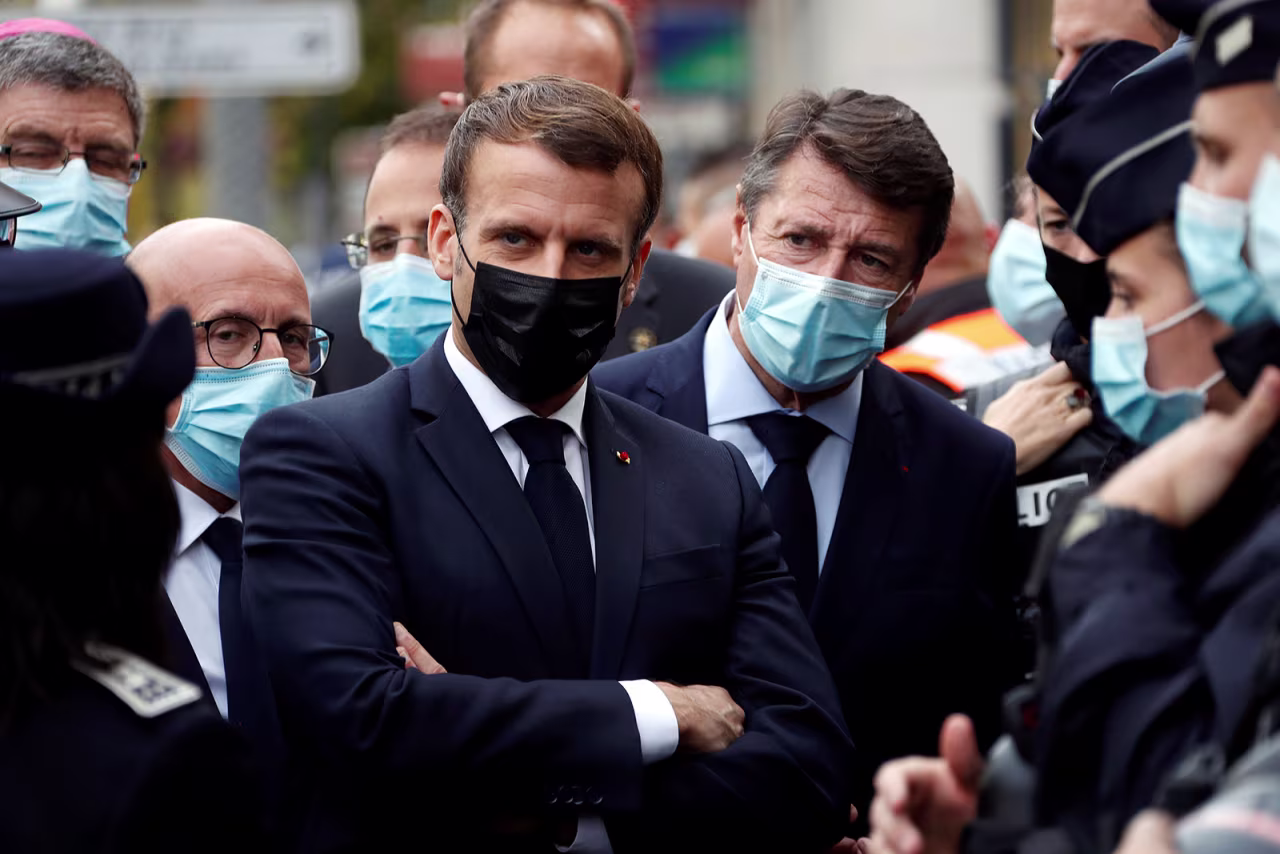 French President Emmanuel Macron visits the scene of the knife attack in Nice.