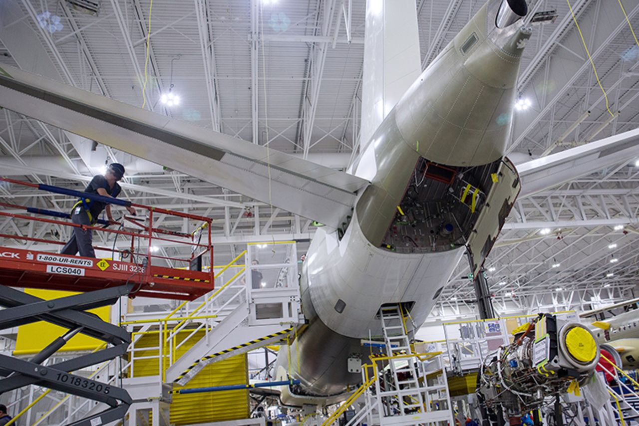 A worker prepares to install an engine on an Airbus SE A220 plane on the assembly line at the Airbus Canada LP assembly and finishing site in Mirabel, Quebec, Canada, on February 20.