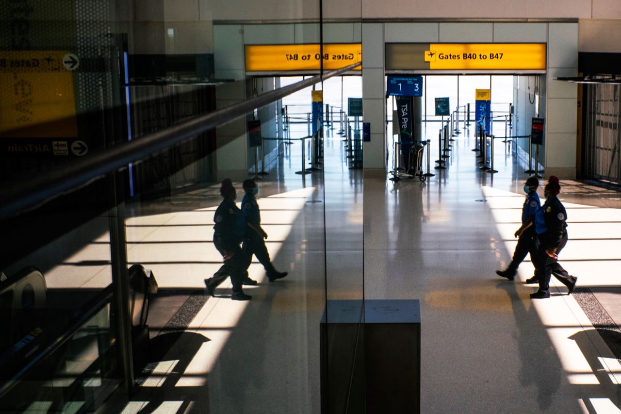 Transportation Security Administration workers walk through Newark Liberty International Airport in New Jersey on September 8, when the new COVID-19 testing facility, XpresCheck, was made available for passengers.