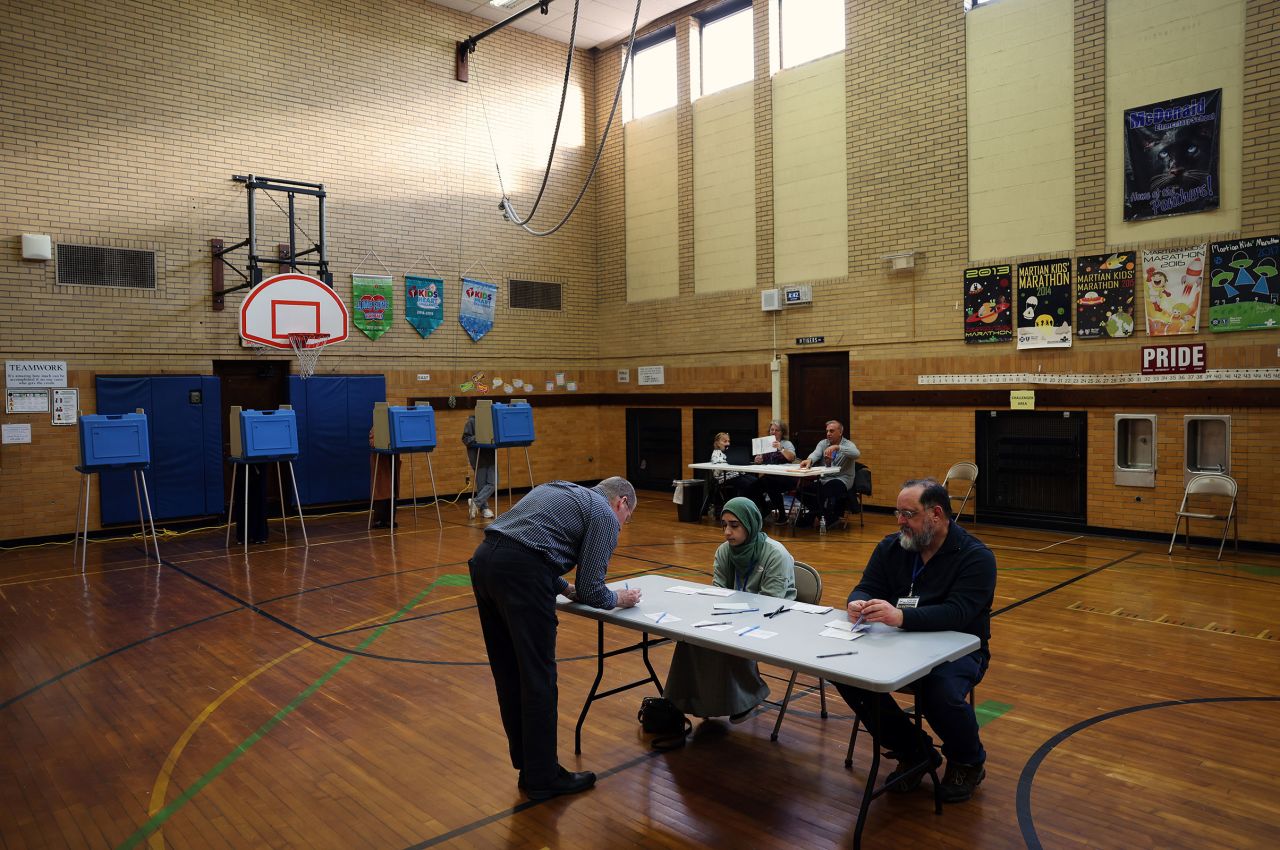 A voter checks-in to cast their ballot in the Michigan primary election at McDonald Elementary School on February 27 in Dearborn, Michigan.