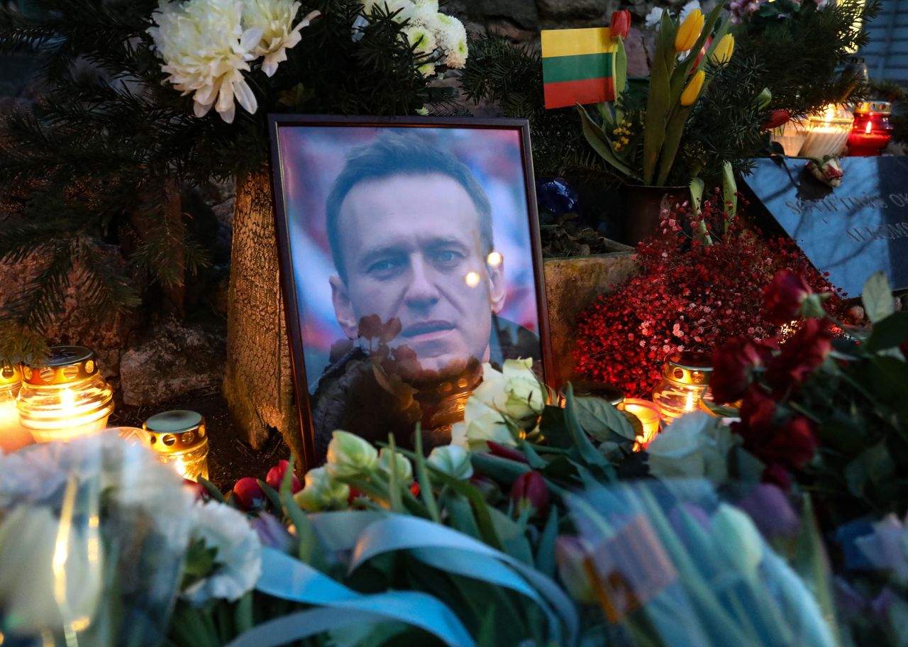 Flowers and a picture of late Russian opposition leader Alexei Navalny lay at a makeshift memorial as people demonstrate and pay their respect following his death in prison, at the monument for victims of political repressions in Vilnius, Lithuania, on February 16.