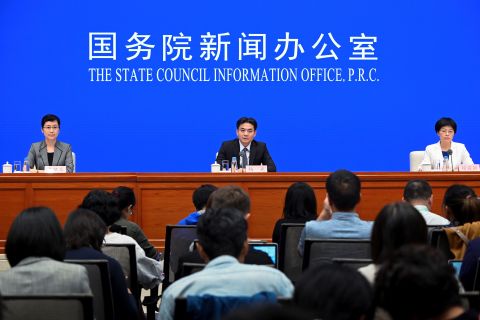 Yang Guang (C) and Xu Luying (R), spokespersons for mainland China's Hong Kong and Macao Affairs Office attend a press conference in Beijing on July 29.