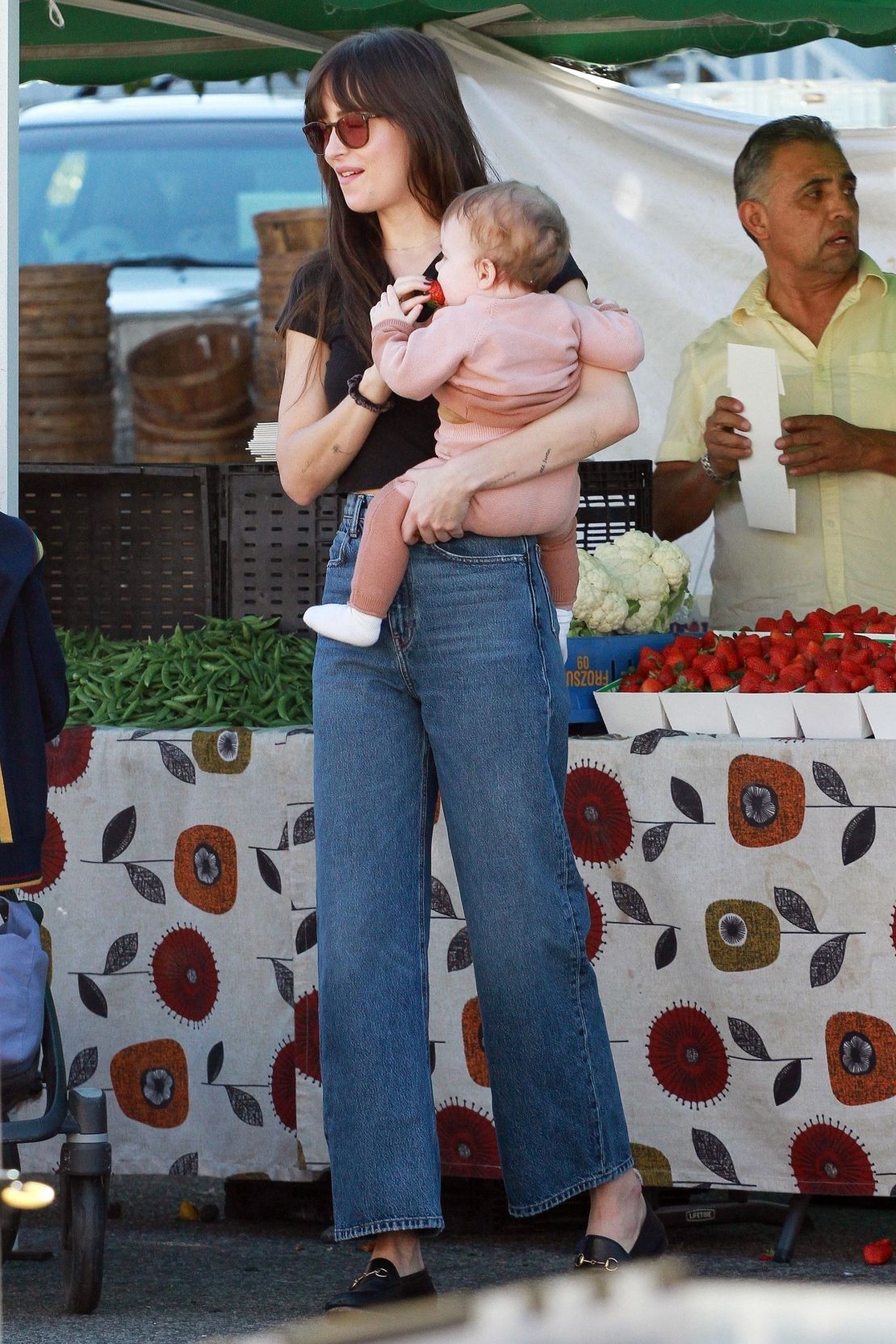 In 2019, Dakota Johnson, photographed here with Addison Timlin and her daughter Ezer Billie White, went viral for the outfit she wore at a local farmers market in the area. Particularly, the style of her jeans.