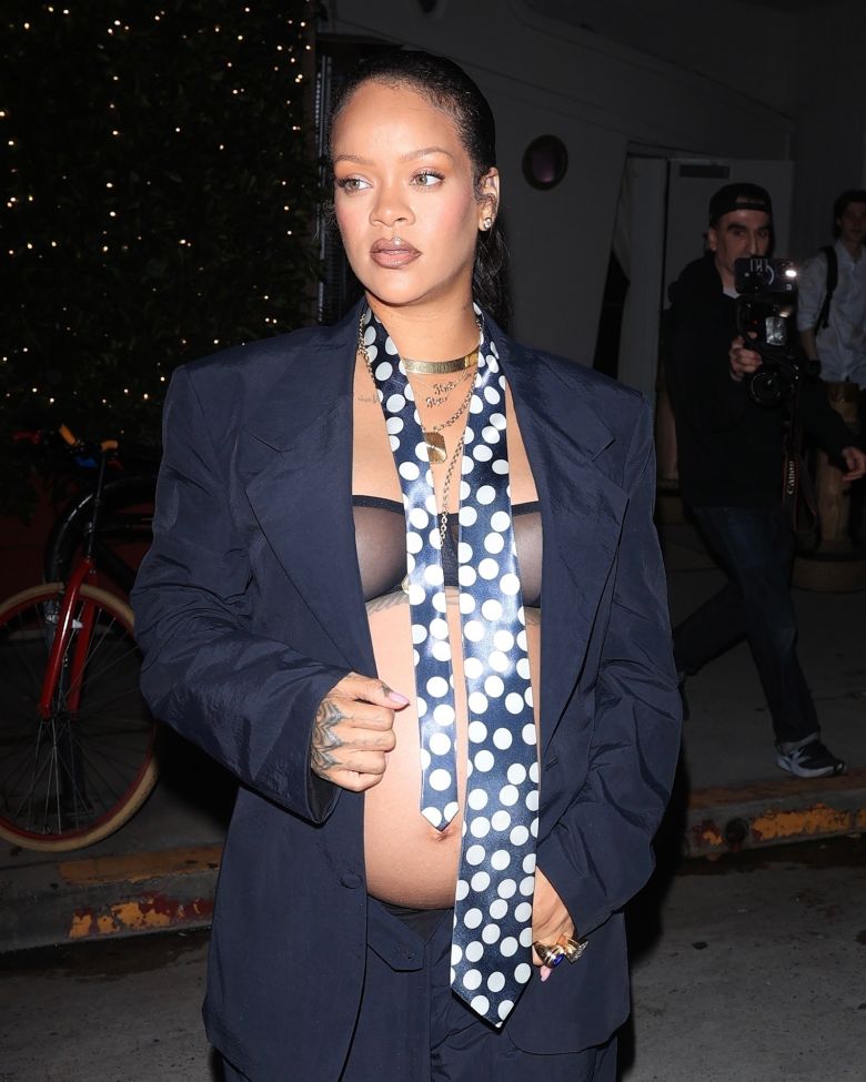 Pictured in Santa Monica, Rihanna styled her navy suit with a custom polka dot tie by American fashion label ERL.