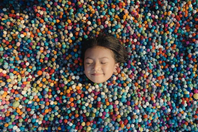 While at a felt ball factory in Nepal, Bibek Kunwar took a photograph of a little girl submerged in them. Winner, National Awards.