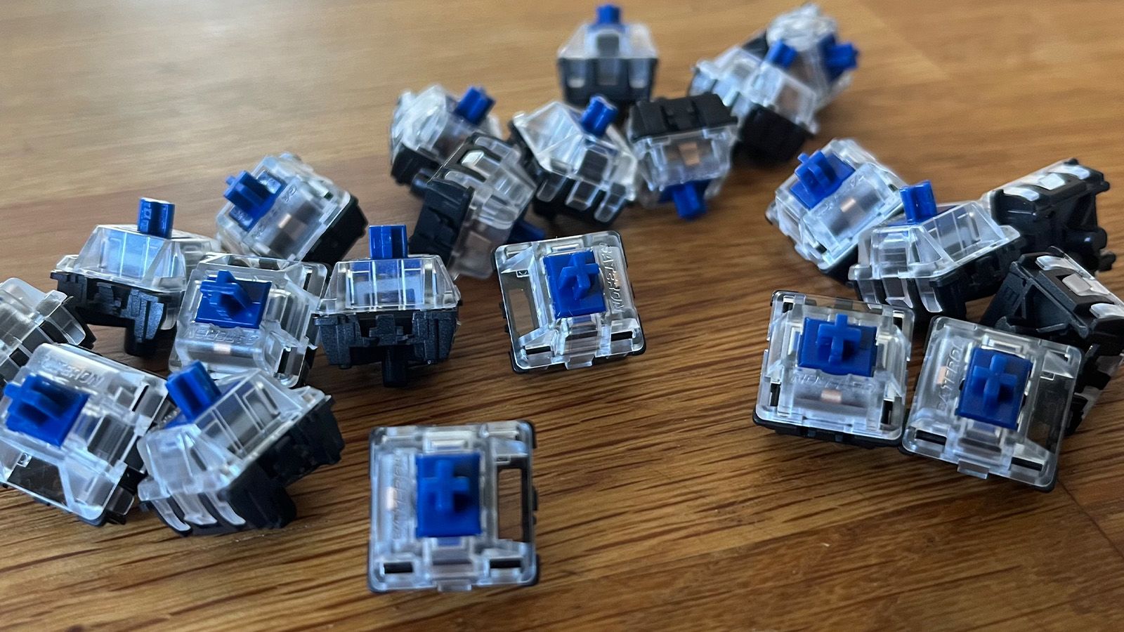 A group of mechanical keyboard switches, of the clicky "blue" type.