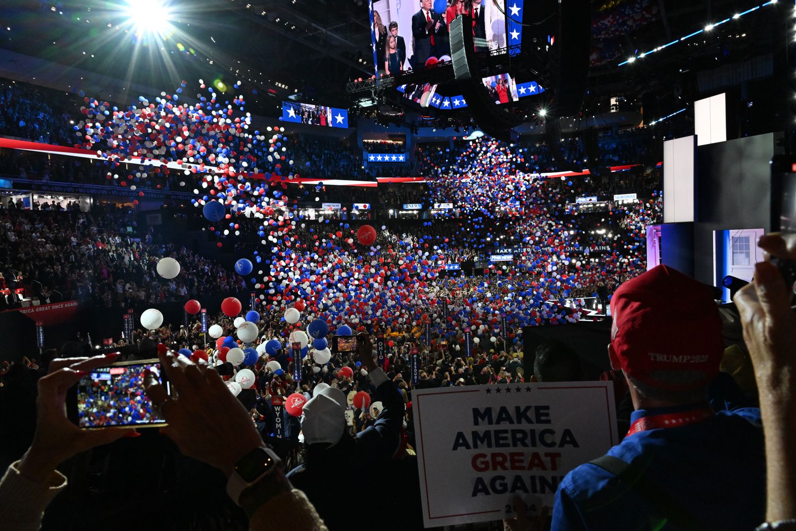 Convention attendees take photos and videos at the end of Trump's speech on Thursday.