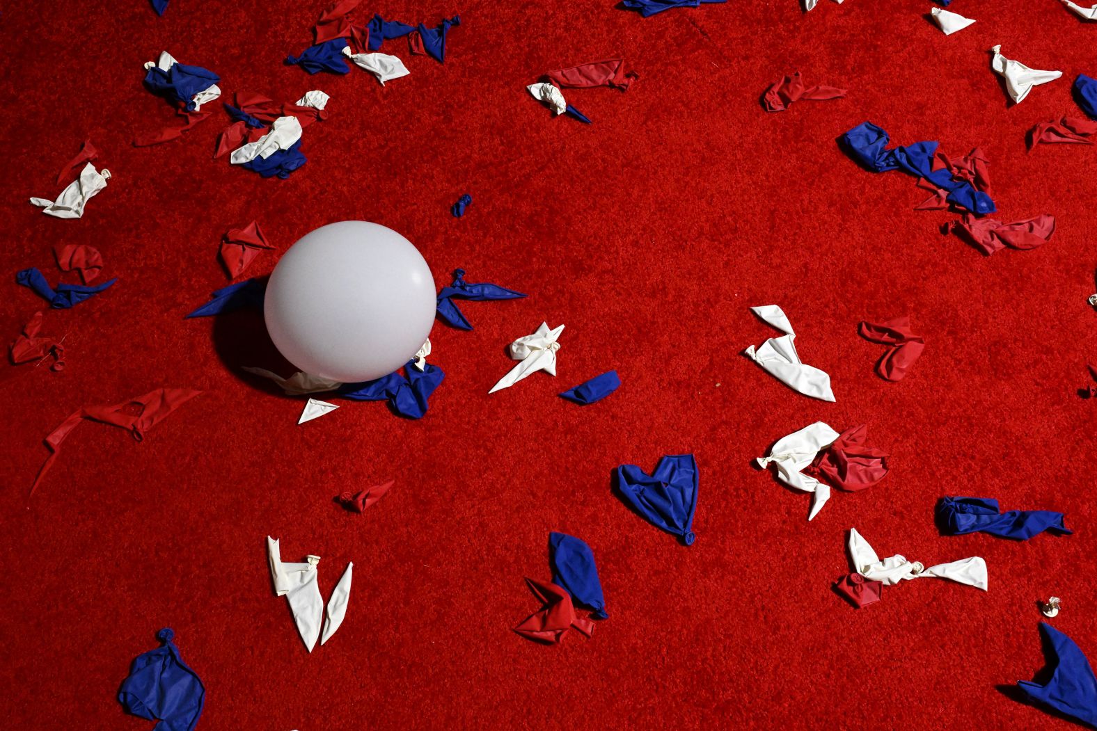 Popped balloons cover the floor of the Fiserv Forum in Milwaukee.