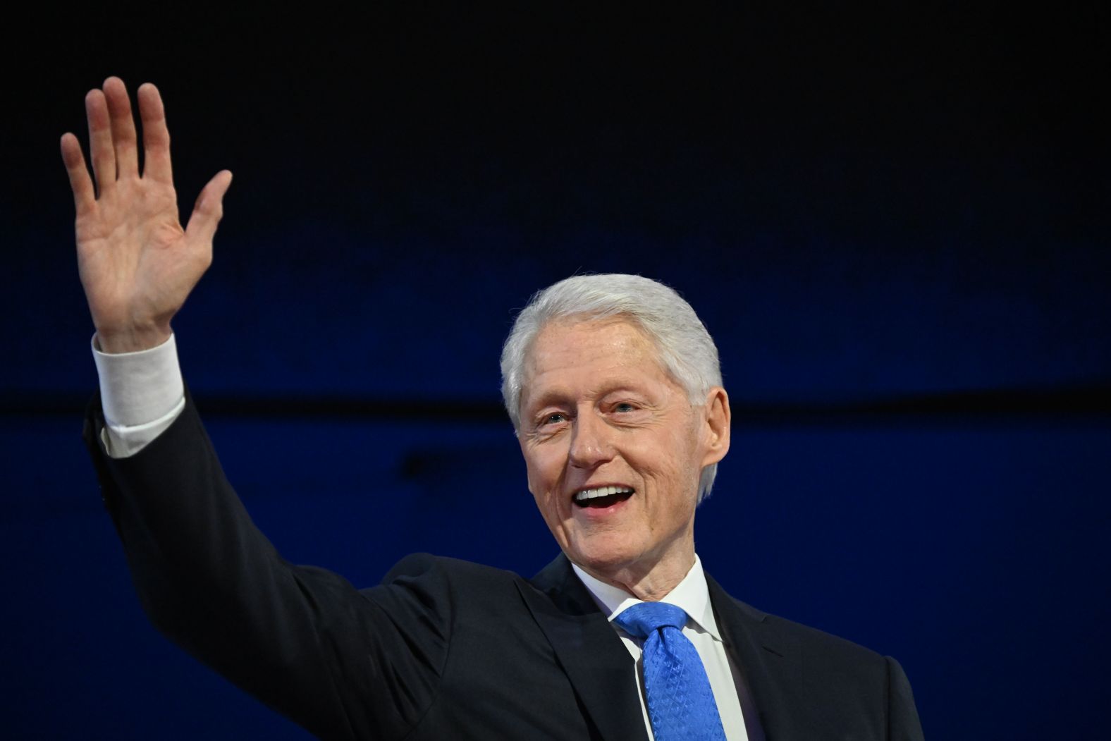 Former President Bill Clinton waves to the crowd on Wednesday. “In 2024, we've got a pretty clear choice, it seems to me,” <a >Clinton said in his speech</a>. “Kamala Harris, for the people, and the other guy, who has proved even more than the first go-around that he’s about me, myself and I.”