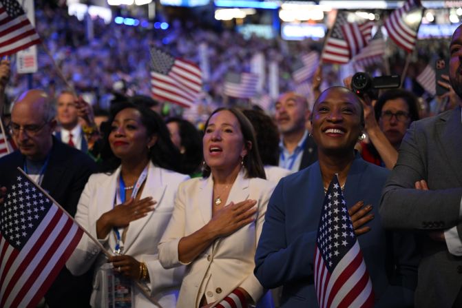 People place their hands over their hearts as <a href="https://www.cnn.com/politics/live-news/dnc-democratic-national-convention-08-22-24#h_8d5800402c2f1c34609a2768933f13a3">The Chicks sing the National Anthem</a> on Thursday.