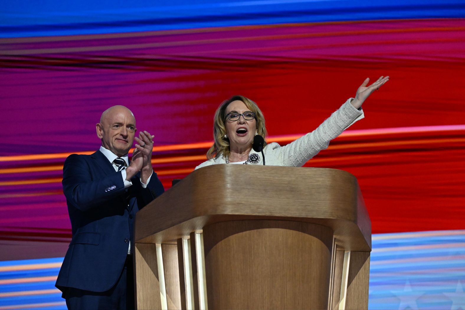 Former US Rep. Gabby Giffords is joined by her husband, US Sen. Mark Kelly, as she gives a speech on Thursday. Giffords threw her support behind Harris as <a >she recalled being wounded during a mass shooting in 2011</a>. "My friend Kamala will be a great president,” Giffords said, adding that “Kamala can beat the gun lobby. She can fight gun trafficking.”