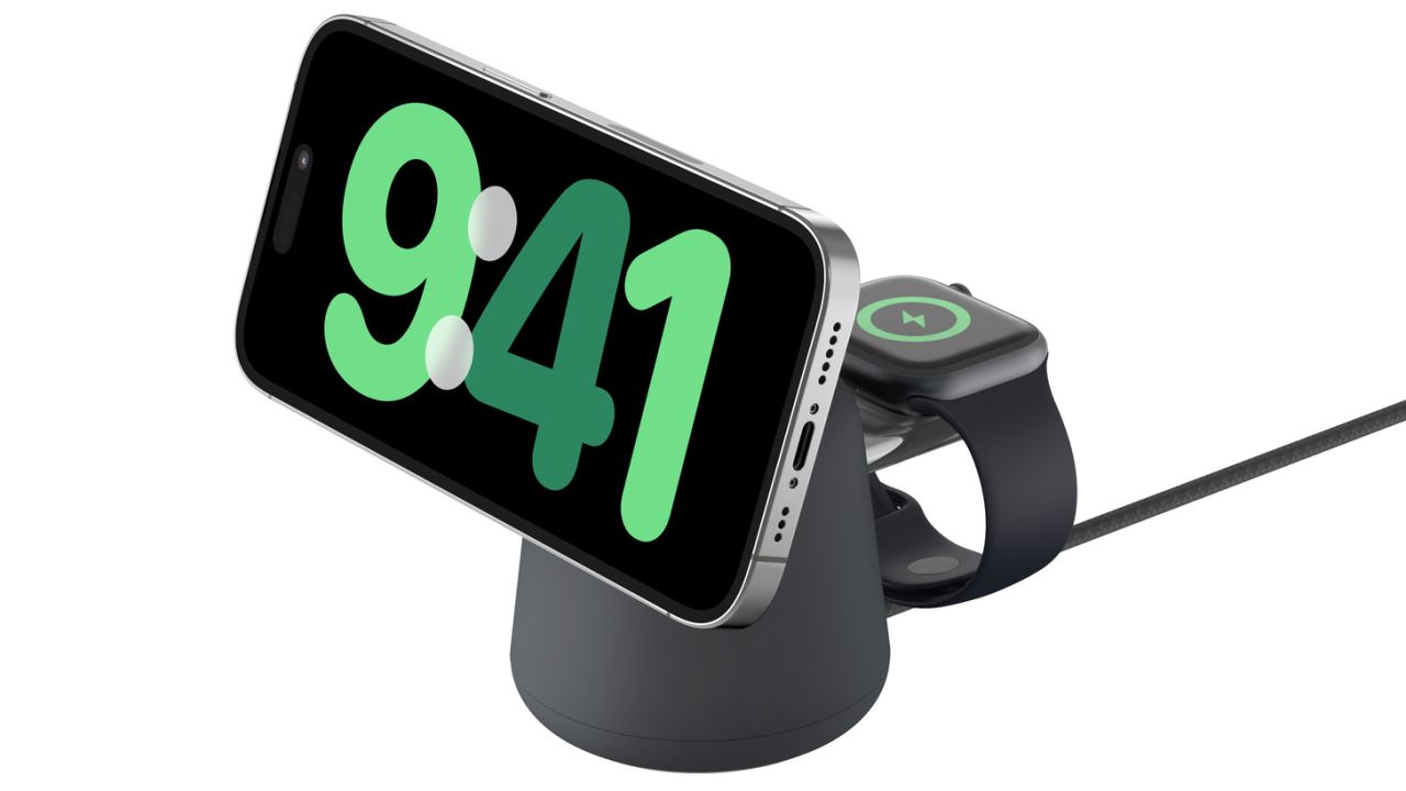 the Belkin 2-in-1 MagSafe Wireless Charging Dock 15W with an iPhone in standby mode showing the time in big colorful numbers, and an apple watch charging on the back.