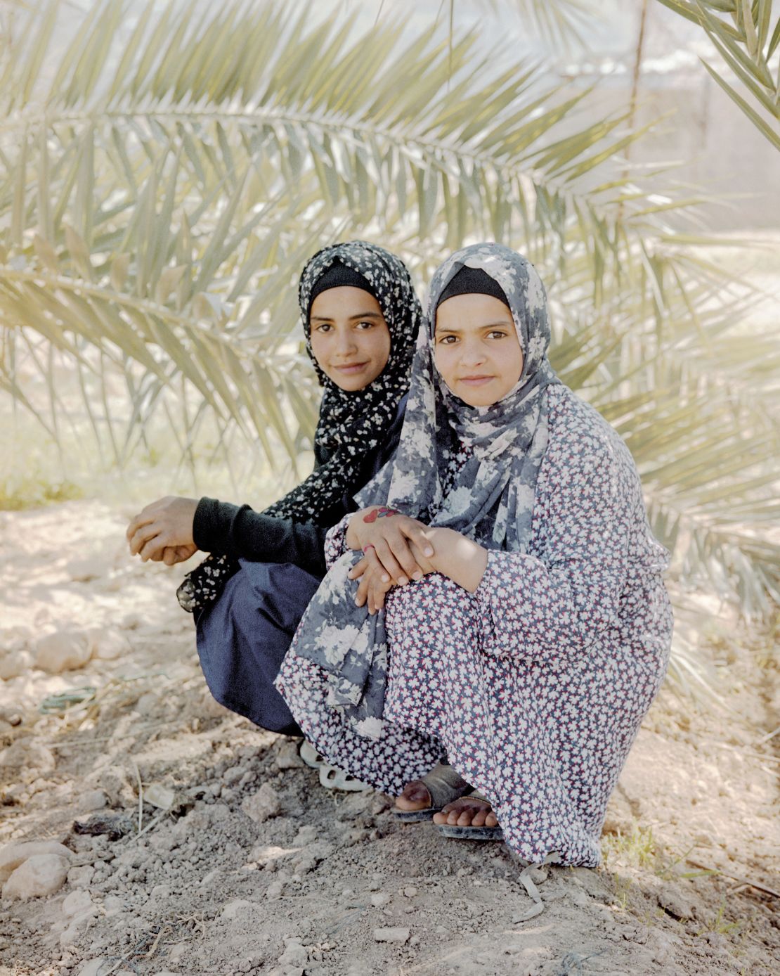 Sisters Chaula (left) and Hanin (right) retain a close bold while navigating different childhoods: Chaula does not attend school so she can help her mother at home, while Hanin balances her studies with taking care of her pigeons.