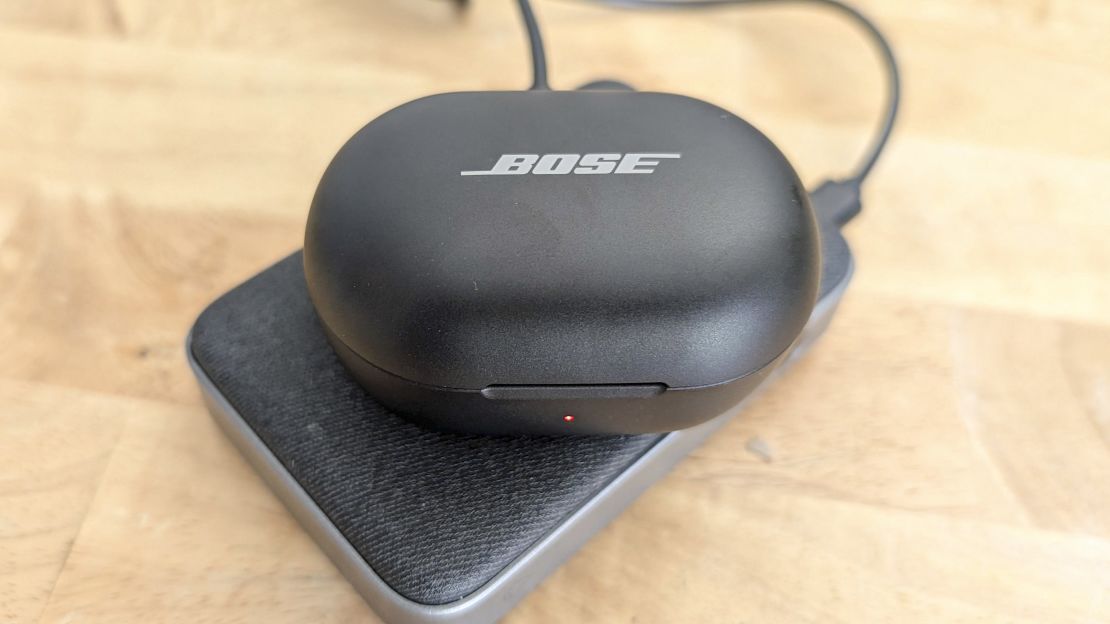 Bose QuietComfort Earbuds on top of charger.