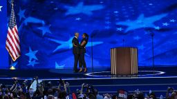 Former President Barack Obama and Michelle Obama embrace on stage on Tuesday, August 20, during the DNC in Chicago.