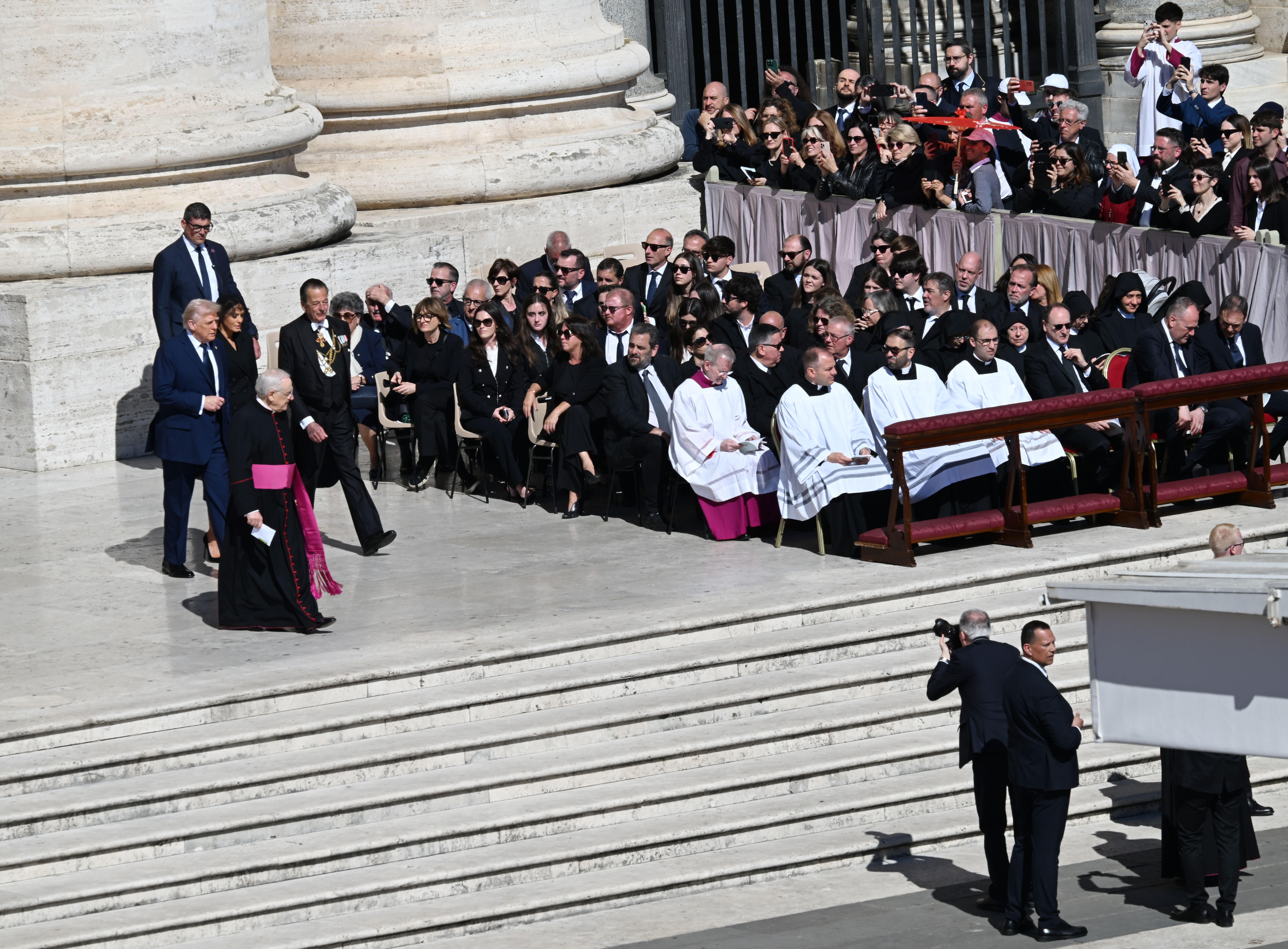 US President Donald Trump and first lady Melania Trump arrive at the funeral on Saturday.