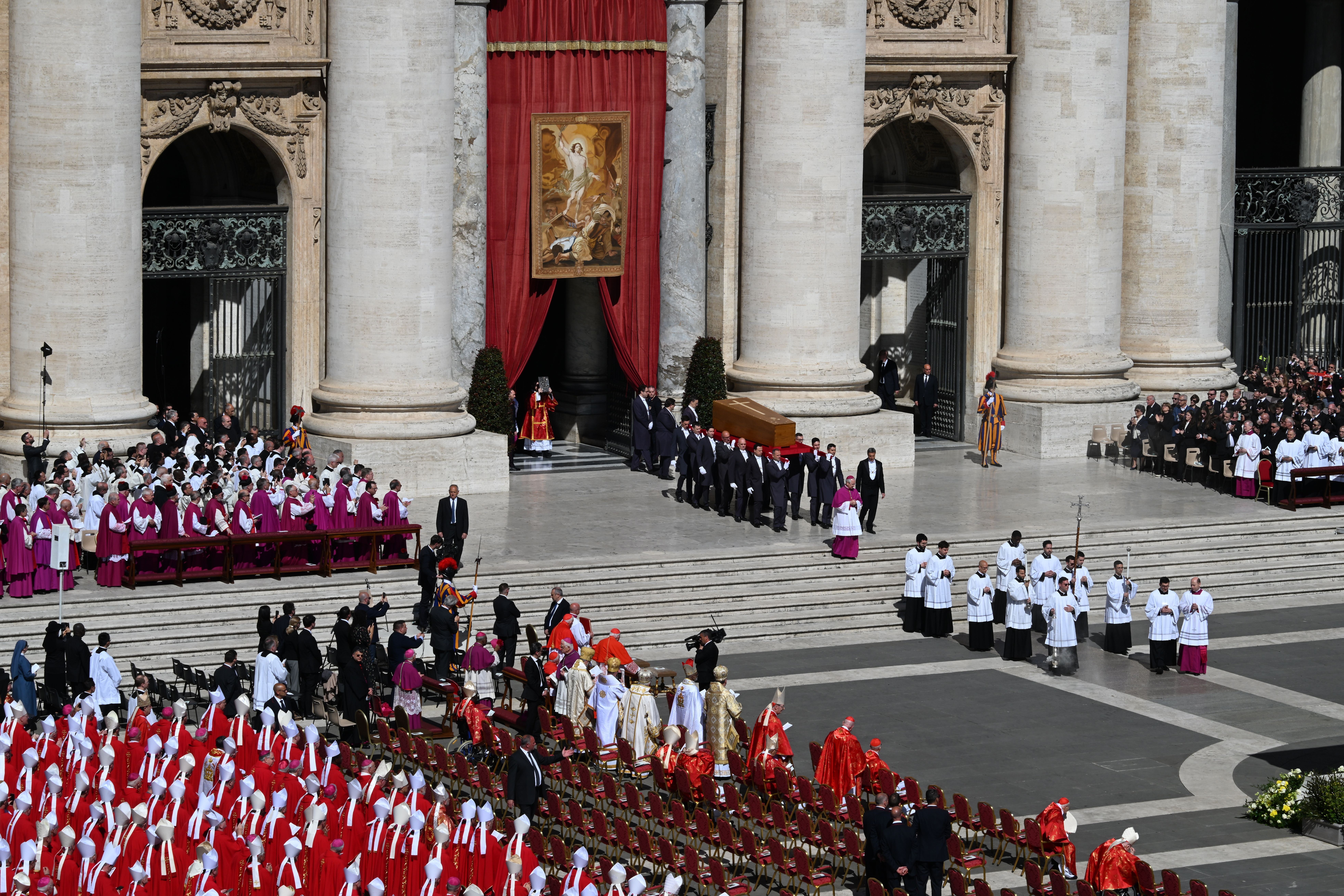 The pope's coffin is carried into St. Peter's Square for the start of his funeral.