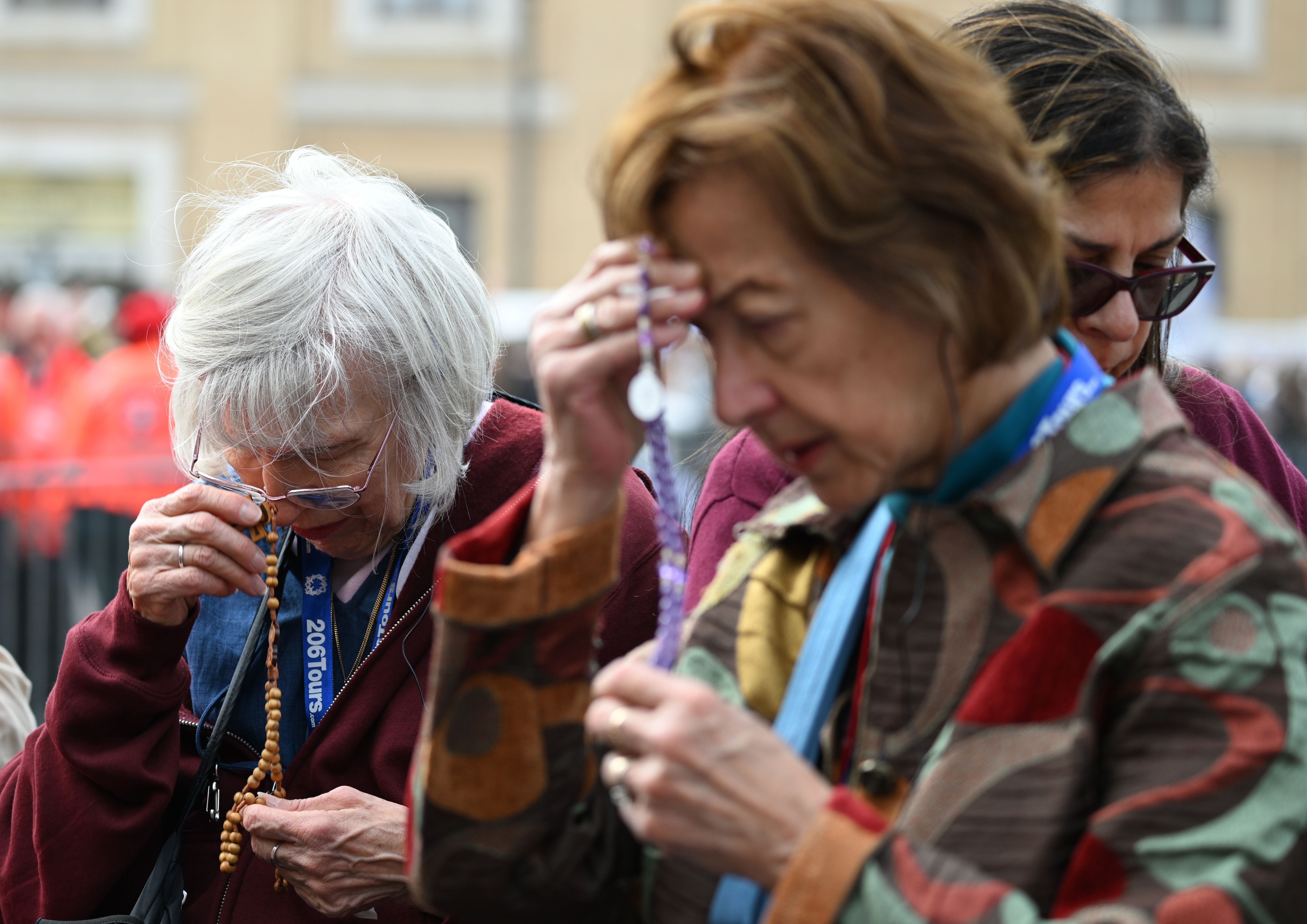 A tour group prays in front of St. Peter's Basilica on Thursday.
