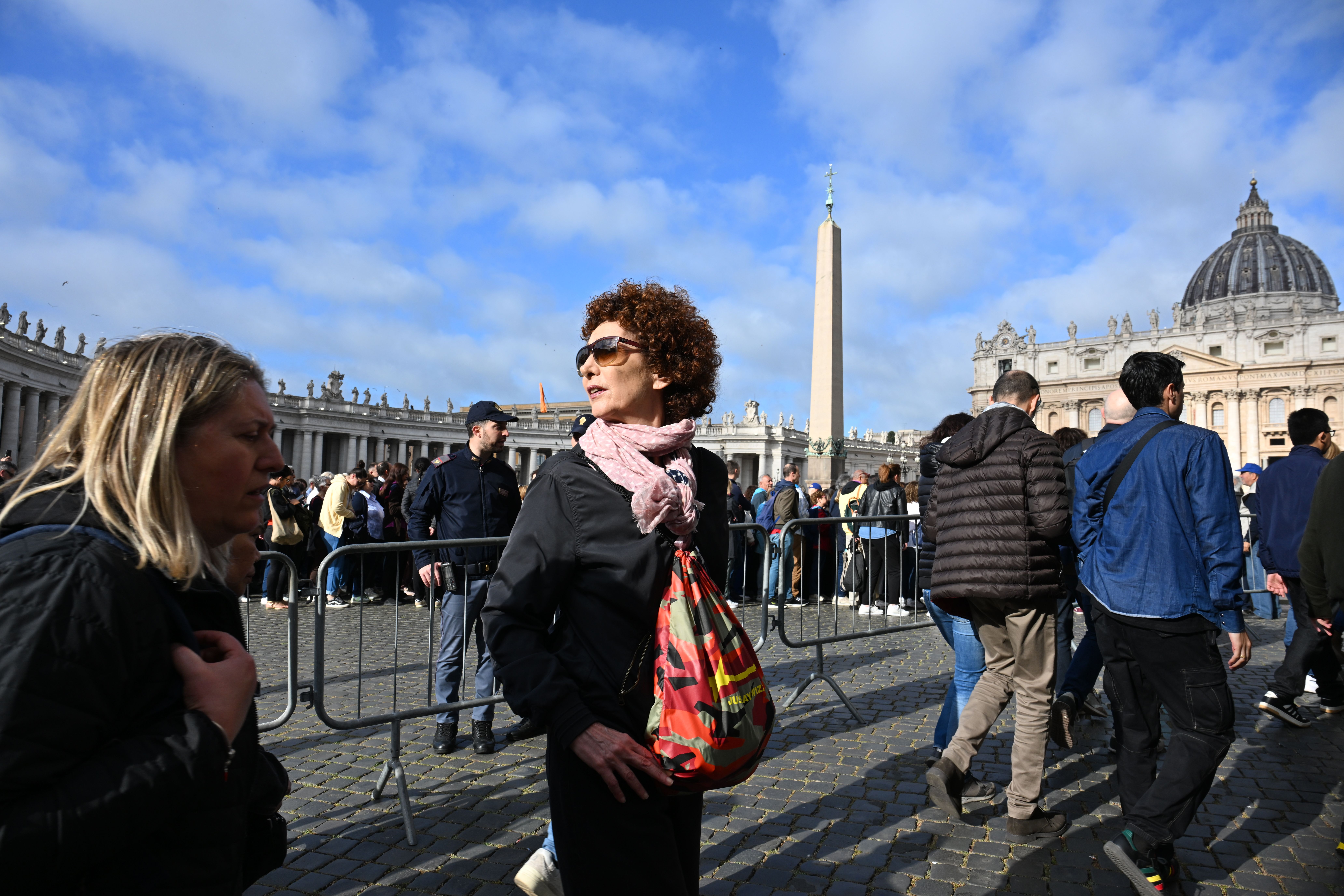 A woman looks back as she reaches the columns of St. Peter's Basilica on Friday.