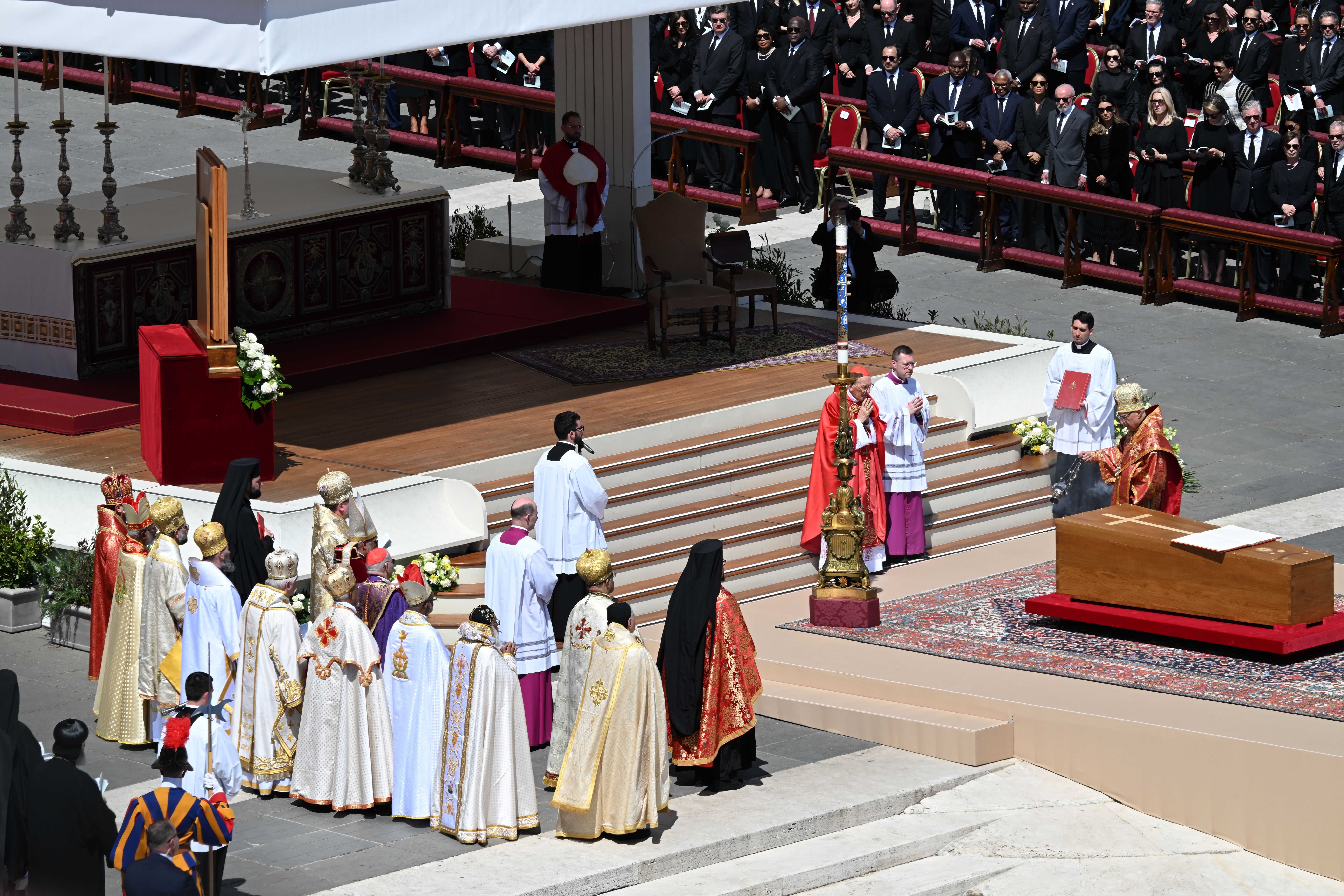 Re blesses the pope's coffin during the funeral.
