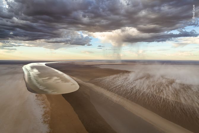 This image by Brad Leue shows floodwater surging towards Kati Thanda-Lake Eyre salt lake in southern Australia.