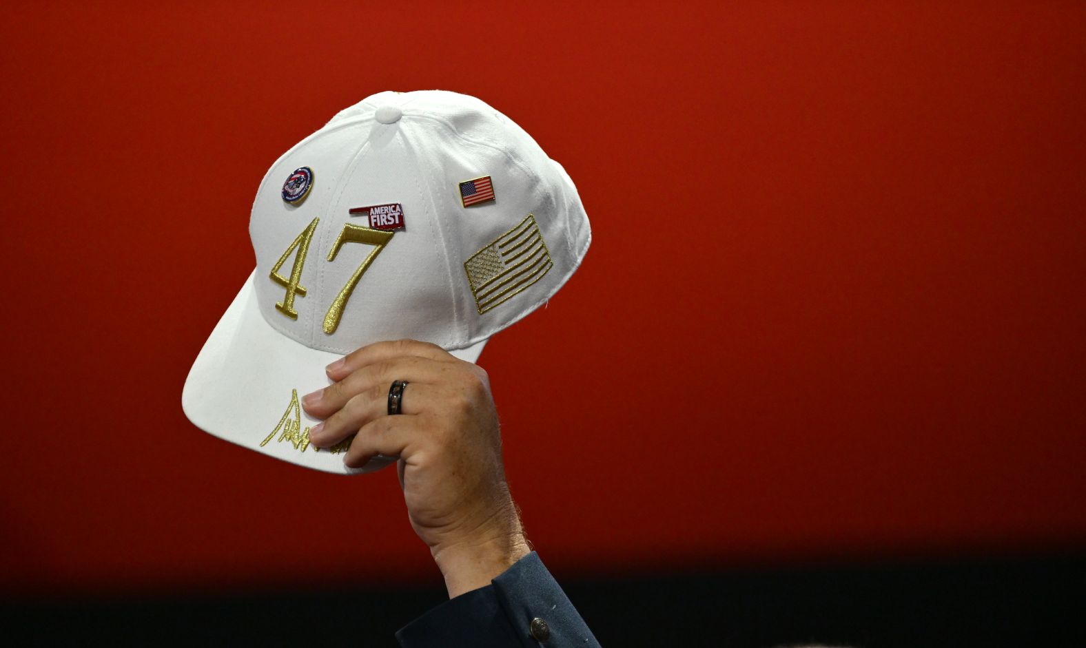 A delegate holds up a hat, showing support for Trump's goal to become the nation's 47th president.