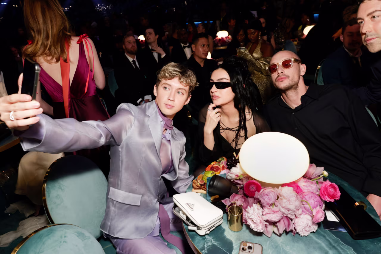 Troye Sivan, Charli XCX and George Daniel take a selfie at the Grammy Awards in Los Angeles on Sunday.