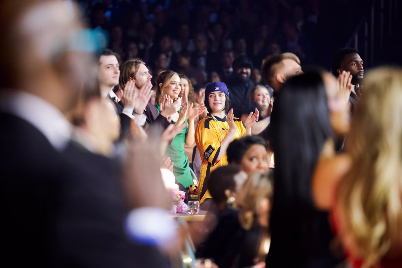 Billie Eilish applauds in the crowd during the show.