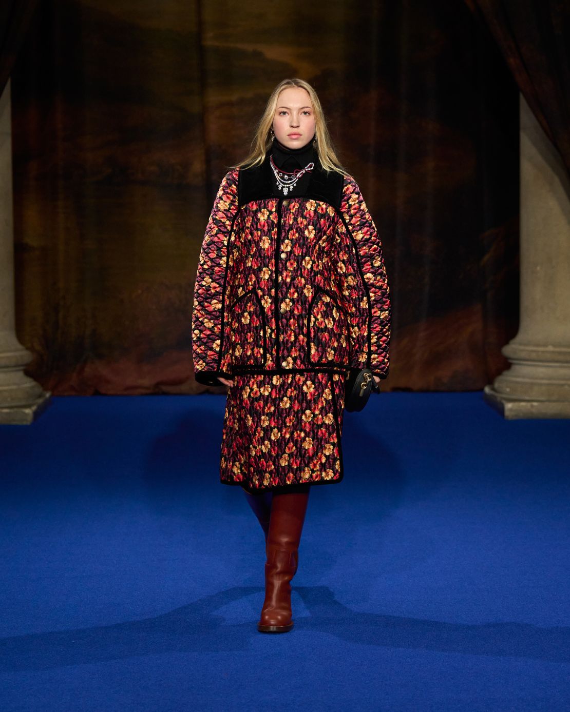 Lila Moss, the daughter of supermodel Kate Moss, walked the show, wearing a matching jacket-skirt set and thigh-high boots.