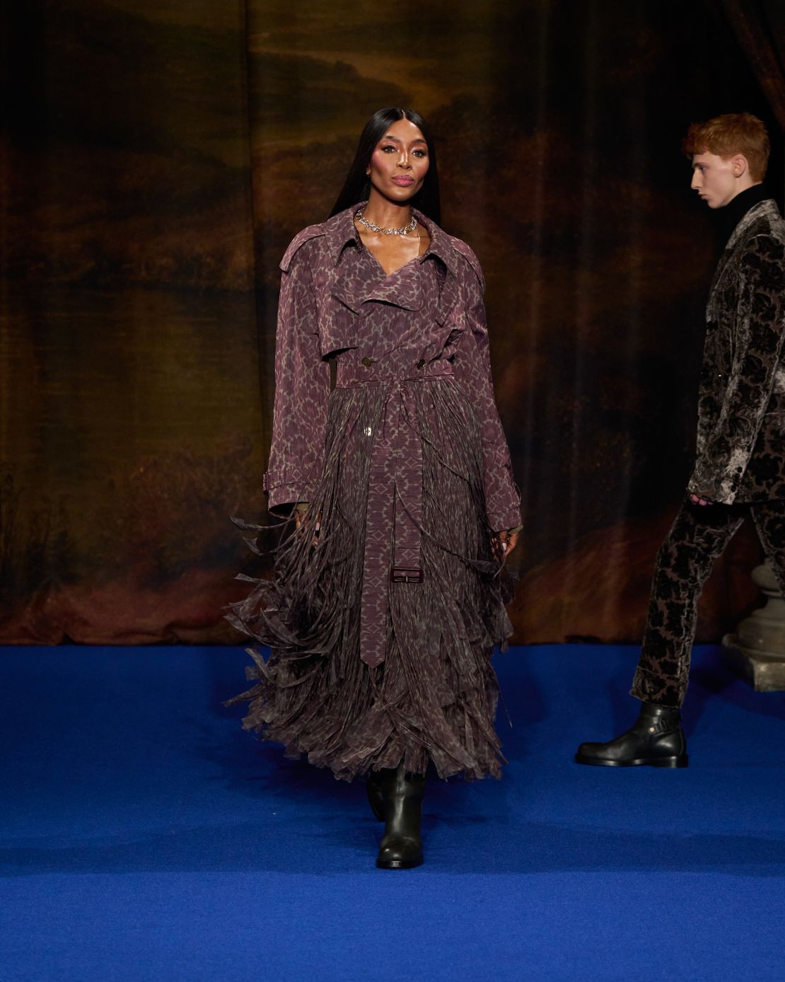 Naomi Campbell, a regular face on the Burberry catwalk, wore a dark purple coat with fringing details.