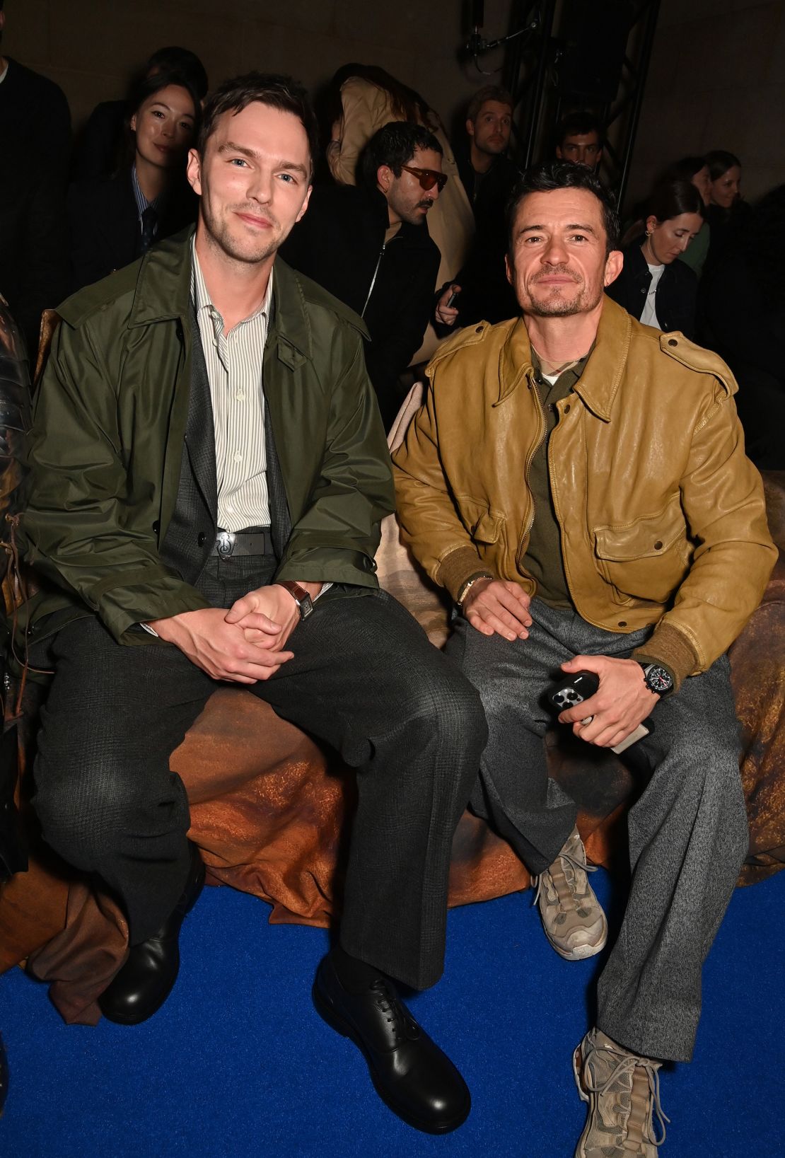 Actors Nicholas Hoult and Orlando Bloom happily chatted with guests as they sat on the front row.