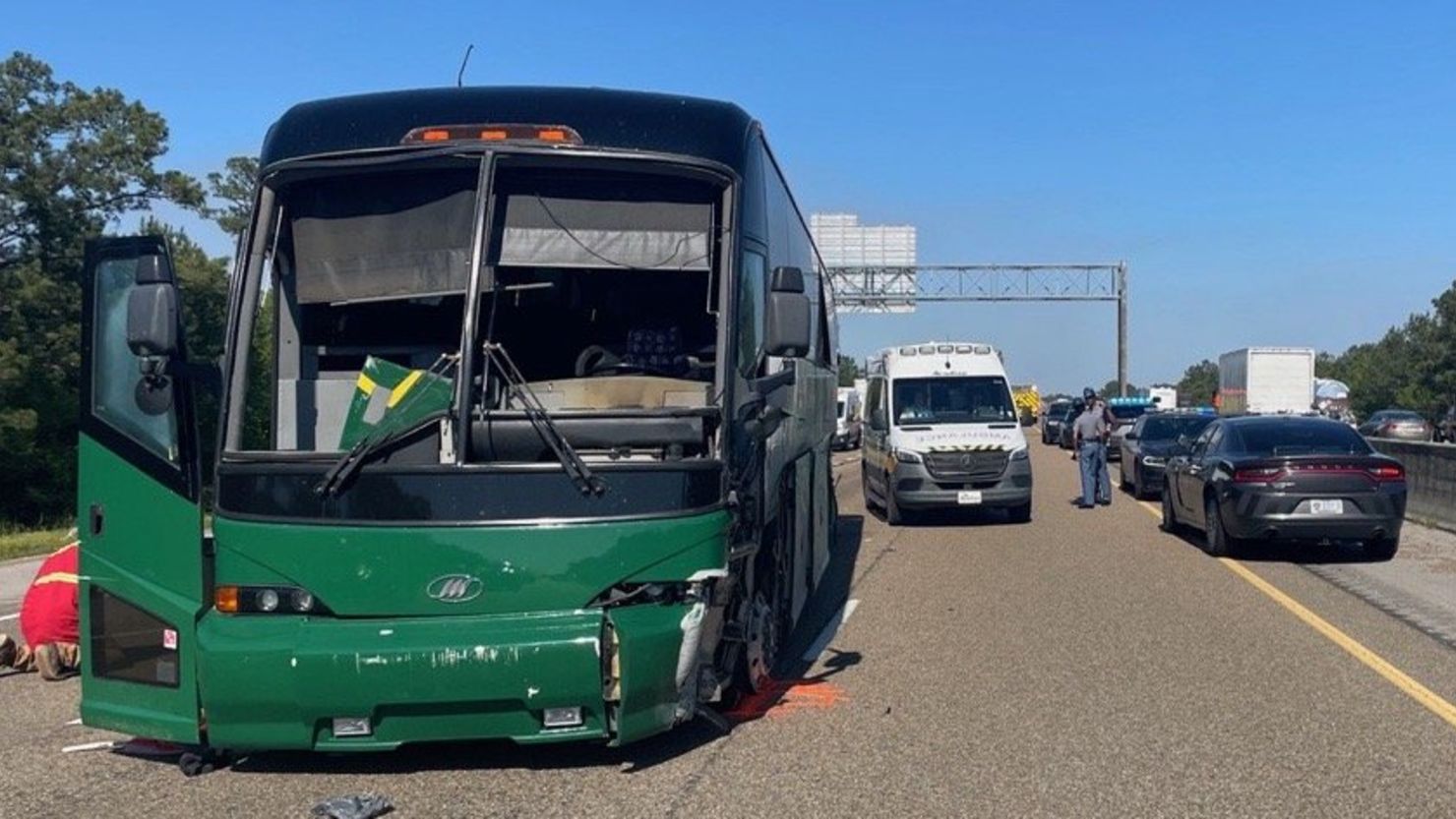 Law enforcement officials direct traffic following an incident involving a charter bus on I-10 westbound past Highway 603 in Hancock County Friday.