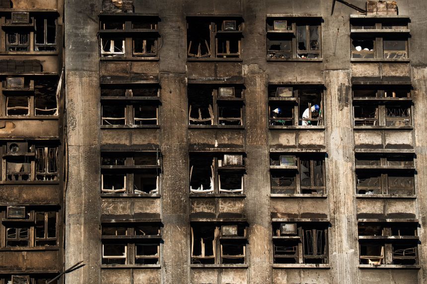 Specialist police search the apartments in Wang Fuk Court complex in Tai Po, Hong Kong, on December 1, 2025.