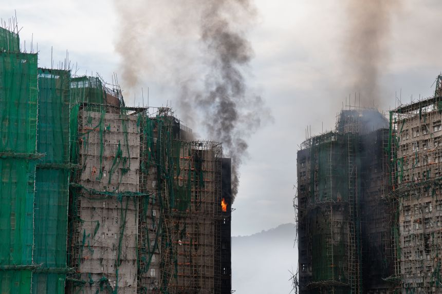 Polystyrene boarded windows behind scaffolding and netting at Wang Fuk Court in Tai Po, Hong Kong, on Thursday.