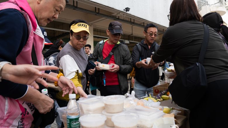 Affected residents recieve donations at a distribution point near the Wang Fuk Court housing estate following a fire in Tai Po, Hong Kong, on November 27, 2025