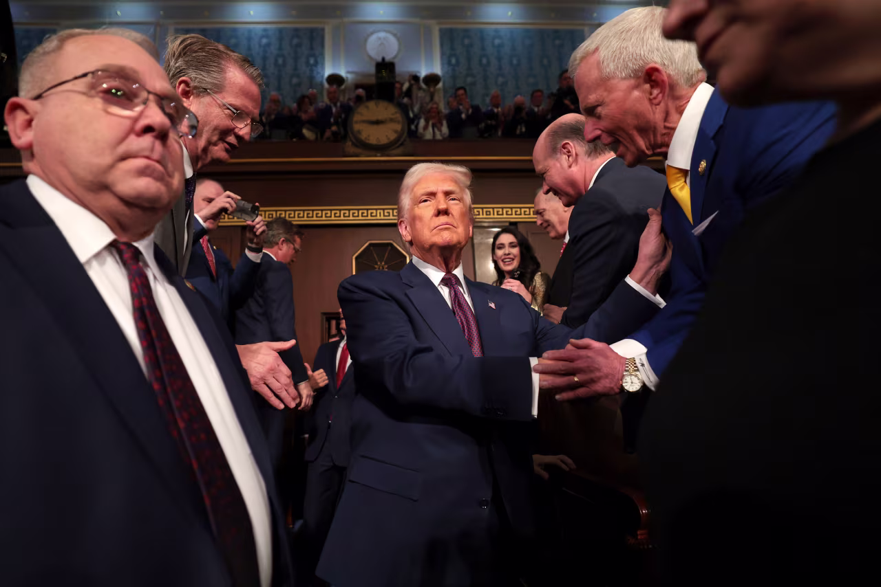 Trump shakes hands with with members of Congress as he arrives.