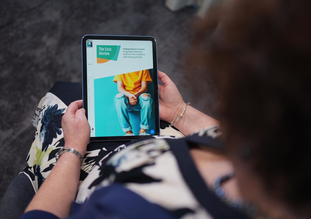 Retired consultant paediatrician Dr. Hilary Cass holds a digital version of the  the Cass Review at the PA Media offices in west London.