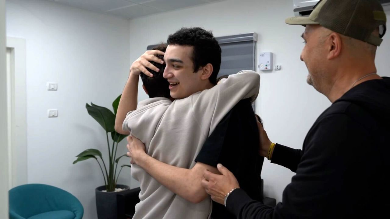 In this photo released by the IDF, Edan Alexander hugs a family member in Re’im, southern Israel, following his release on May 12.