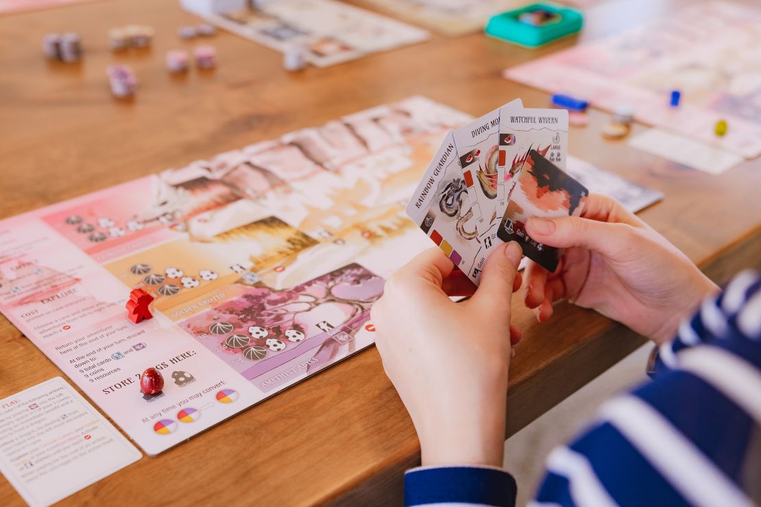 Wyrmspan is a spinoff of the popular game Wingspan — but instead of playing cards with birds, players entice dragons to their board instead.