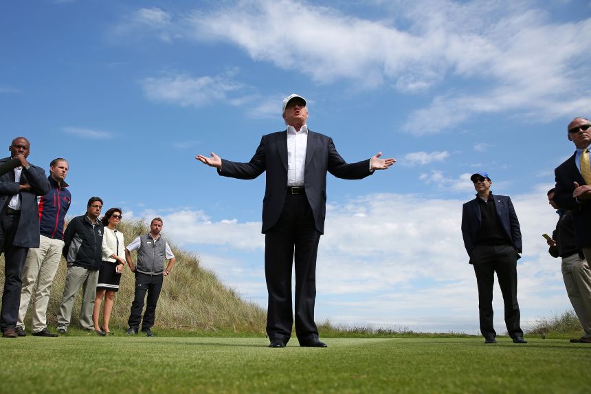 In this June 25, 2016 photo, Donald Trump speaks to the media on the golf course at his Trump International Golf Links in Aberdeen, Scotland.