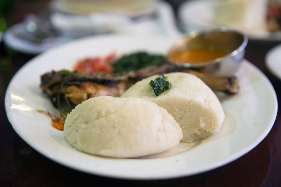Ugali, a dough made with boiled maize flour, is one of Kenya's stable foods. It's typically served with a savory vegetable and meat stew.