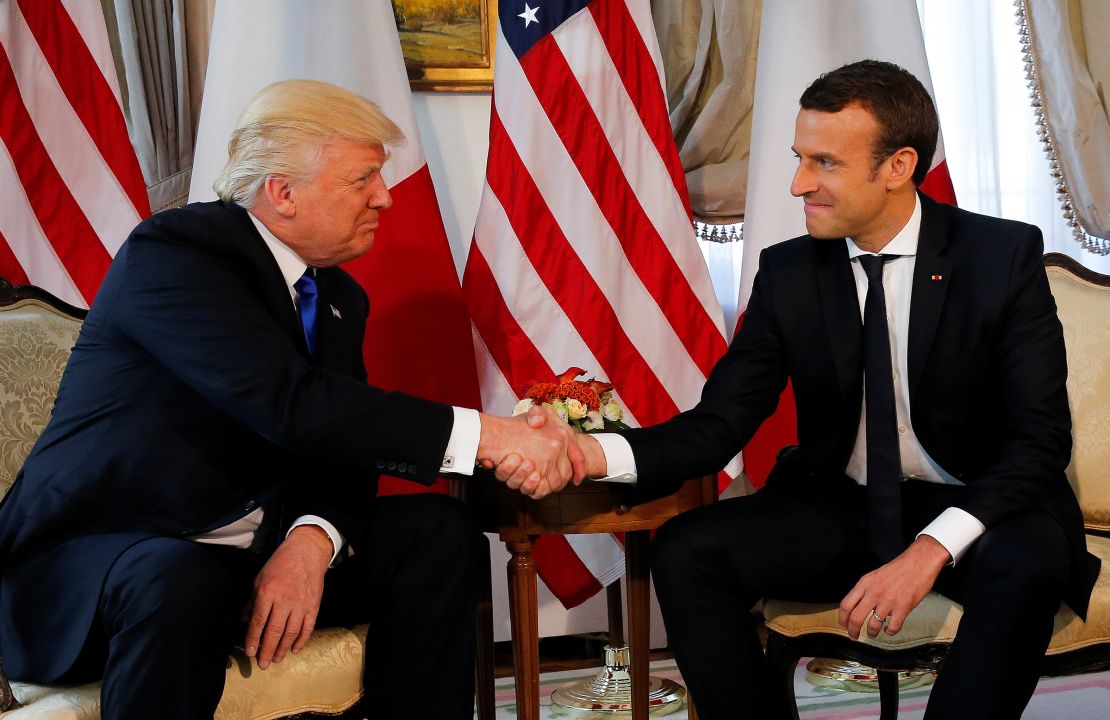 In this May 2017 photo, President Donald Trump and French President Emmanuel Macron shake hands before a lunch ahead of a NATO Summit in Brussels, Belgium.