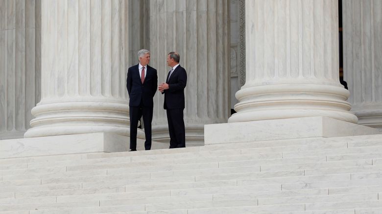 In this 2017 photo, Chief Justice John Roberts, right,  and Justice Neil Gorsuch appear outside the Supreme Court in Washington, DC.